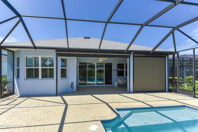 back of house with ceiling fan, a lanai, and a patio