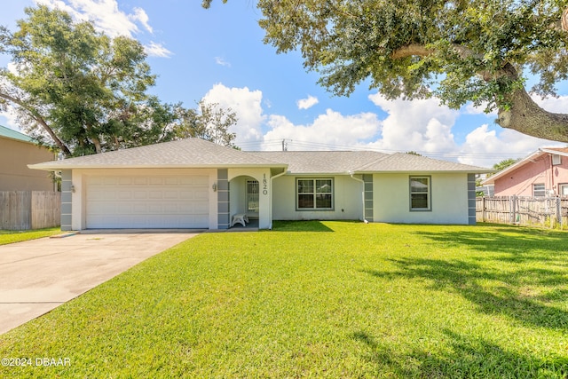 single story home featuring a garage and a front lawn