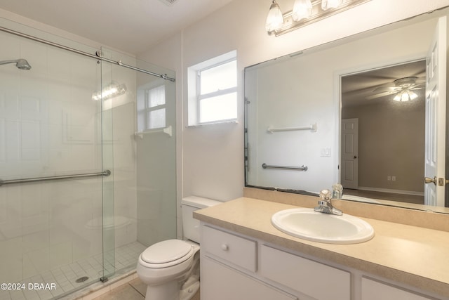 bathroom with vanity, tile patterned flooring, ceiling fan, toilet, and a shower with shower door