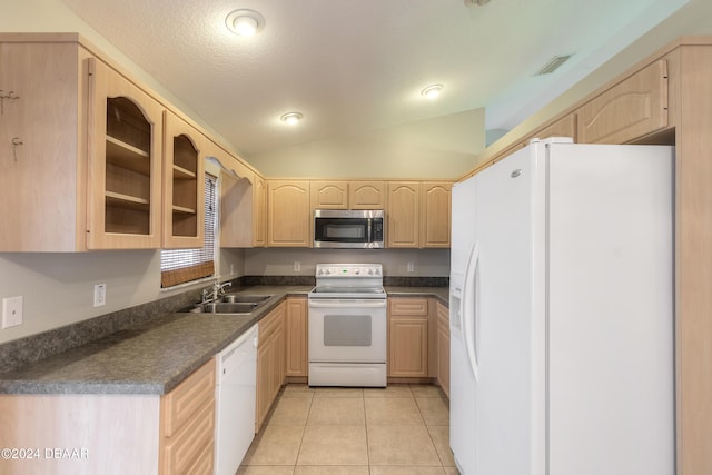 kitchen featuring light brown cabinets, sink, vaulted ceiling, white appliances, and light tile patterned flooring