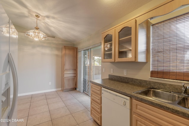 kitchen with sink, light tile patterned floors, dishwasher, hanging light fixtures, and lofted ceiling