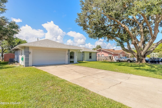 ranch-style house with a front yard, a garage, and central AC unit