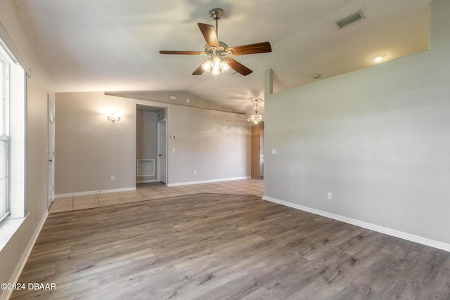 empty room featuring ceiling fan, light hardwood / wood-style floors, and lofted ceiling