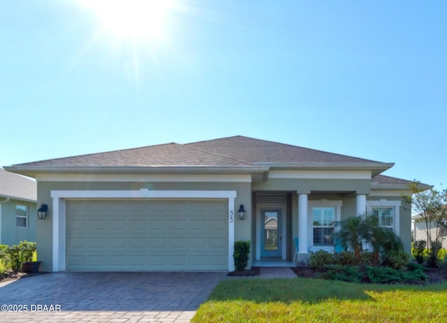 view of front of home featuring a front lawn and a garage