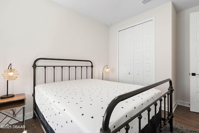56 Los Lagos Blvd, Palm Coast, FL 32137 - bedroom featuring dark wood finished floors, baseboards, and a closet