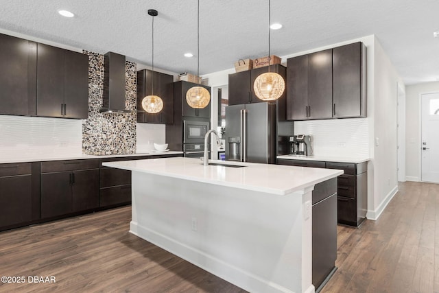 56 Los Lagos Blvd, Palm Coast, FL 32137 - kitchen with appliances with stainless steel finishes, a sink, light countertops, wall chimney range hood, and decorative backsplash
