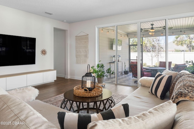 56 Los Lagos Blvd, Palm Coast, FL 32137 - living room featuring wood finished floors, a ceiling fan, and baseboards