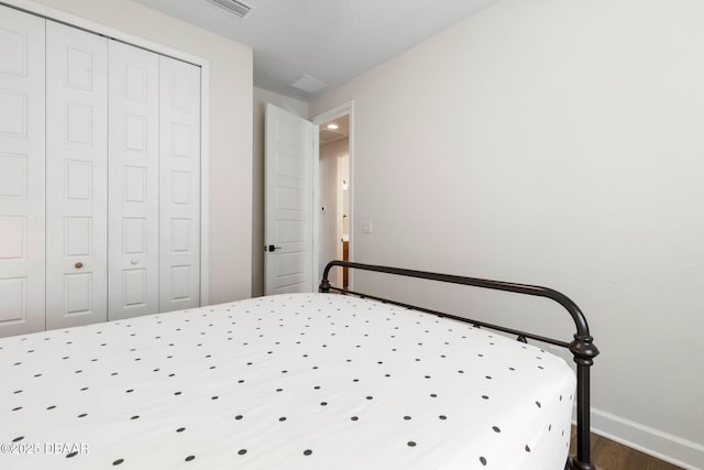 56 Los Lagos Blvd, Palm Coast, FL 32137 - bedroom featuring wood finished floors, baseboards, and a closet