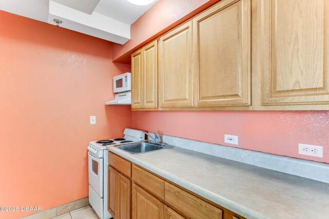 kitchen featuring sink, light tile patterned floors, and white appliances