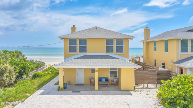 view of front of house featuring a view of the beach and a water view