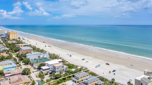 drone / aerial view featuring a water view and a beach view