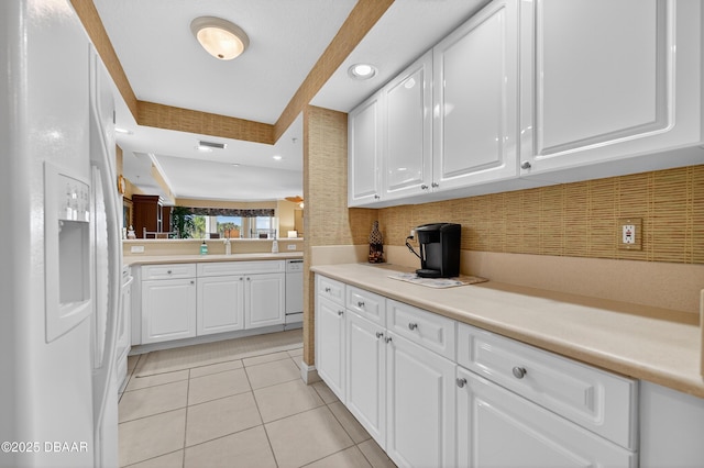4650 Links Village Dr Unit C402, Ponce Inlet, FL 32127 - kitchen featuring white appliances, light tile patterned floors, white cabinets, tasteful backsplash, and recessed lighting