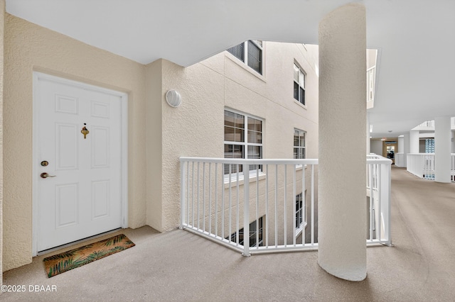 4650 Links Village Dr Unit C402, Ponce Inlet, FL 32127 - doorway to property with stucco siding and a balcony