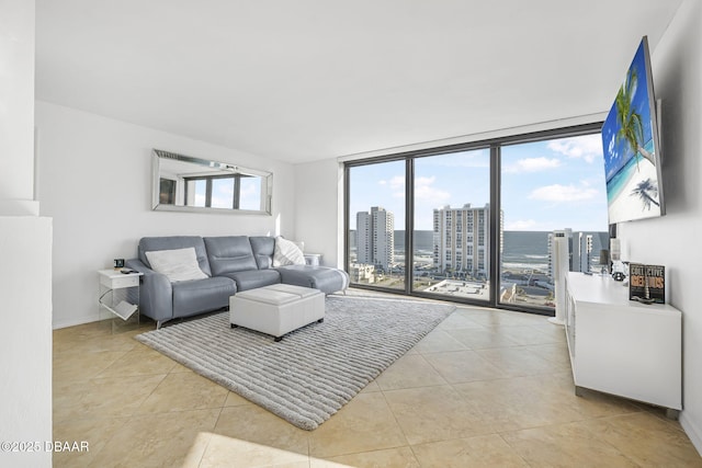 living room featuring light tile patterned flooring and a wall of windows