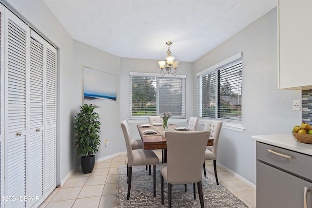 tiled dining area featuring a chandelier