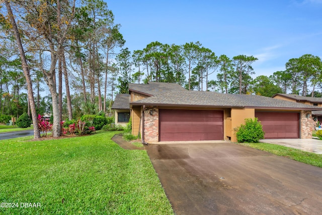 view of front of property with a front lawn and a garage