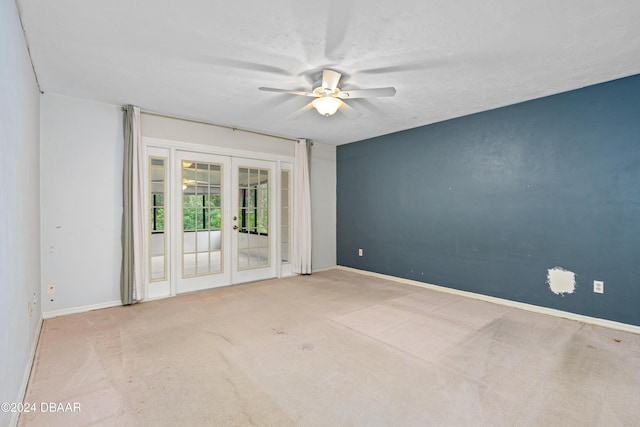 unfurnished room featuring carpet, ceiling fan, a textured ceiling, and french doors