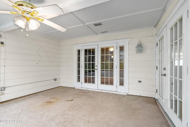 unfurnished sunroom featuring french doors