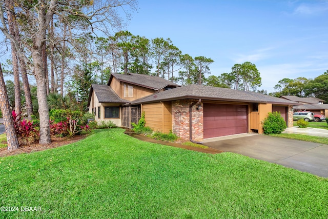 view of front of home with a front lawn and a garage