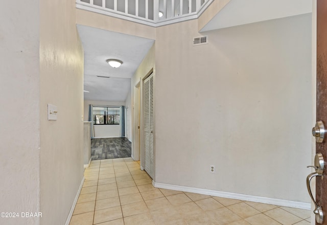 hallway featuring light tile patterned flooring