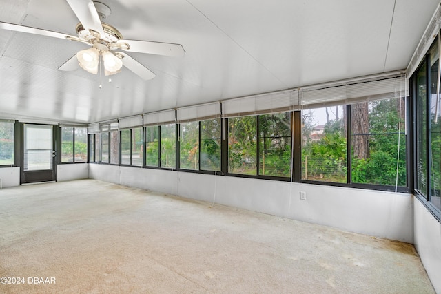 unfurnished sunroom with ceiling fan