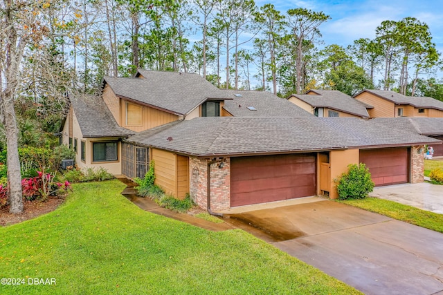 view of front of house with a garage and a front lawn