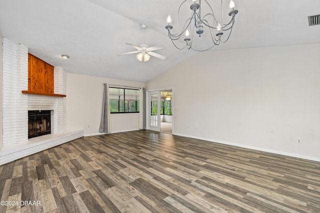 unfurnished living room with ceiling fan with notable chandelier, wood-type flooring, a fireplace, and vaulted ceiling