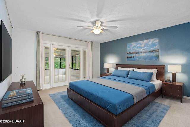 carpeted bedroom with ceiling fan, access to outside, and french doors