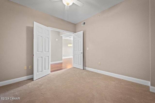 unfurnished bedroom with ceiling fan and carpet floors