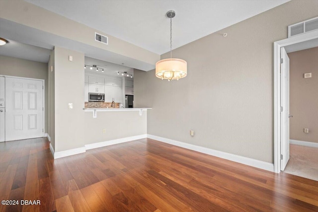 unfurnished living room featuring dark hardwood / wood-style floors