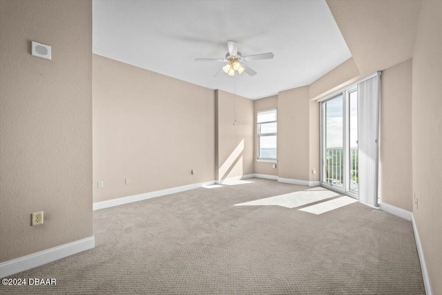 carpeted spare room featuring ceiling fan