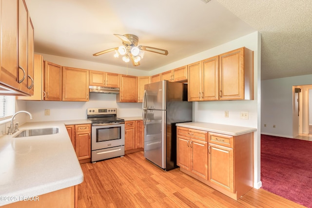 5060 Audubon Ave, Deleon Springs, FL 32130 - kitchen featuring stainless steel appliances, under cabinet range hood, a ceiling fan, light countertops, and light wood-type flooring