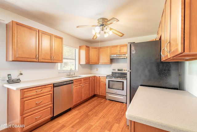 5060 Audubon Ave, Deleon Springs, FL 32130 - kitchen with stainless steel appliances, under cabinet range hood, ceiling fan, light wood-style flooring, and light countertops