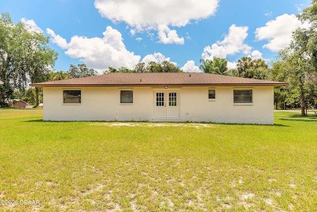 5060 Audubon Ave, Deleon Springs, FL 32130 - rear view of house with french doors, stucco siding, and a lawn