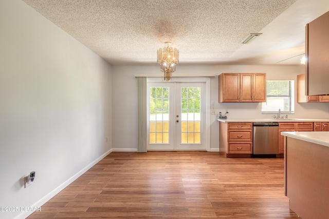 5060 Audubon Ave, Deleon Springs, FL 32130 - kitchen featuring dishwasher, light countertops, french doors, healthy amount of natural light, and a textured ceiling