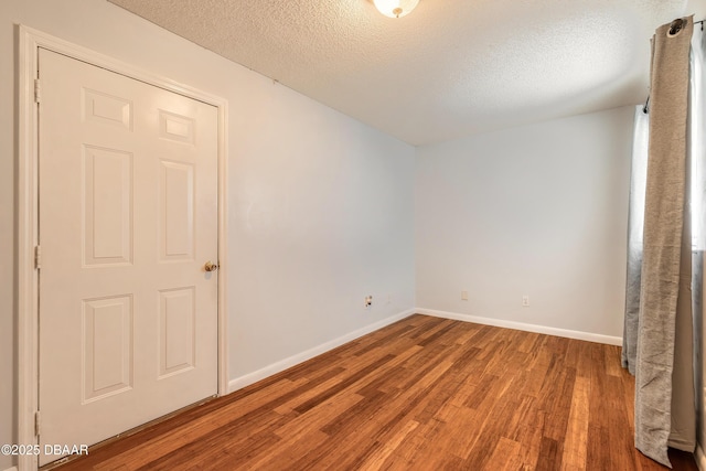 5060 Audubon Ave, Deleon Springs, FL 32130 - spare room featuring wood finished floors and a textured ceiling