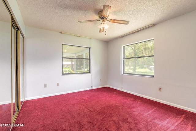 5060 Audubon Ave, Deleon Springs, FL 32130 - unfurnished bedroom featuring a textured ceiling, carpet floors, a closet, and ceiling fan