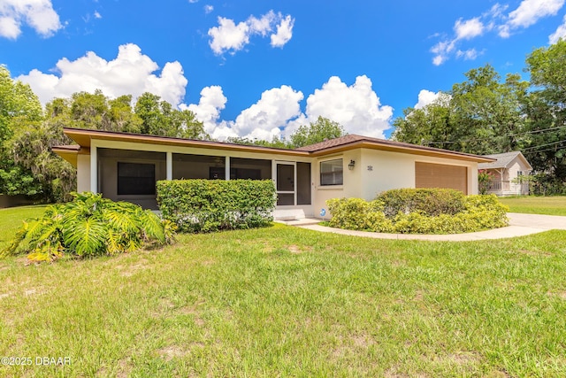 5060 Audubon Ave, Deleon Springs, FL 32130 - single story home with stucco siding, a front yard, and a garage