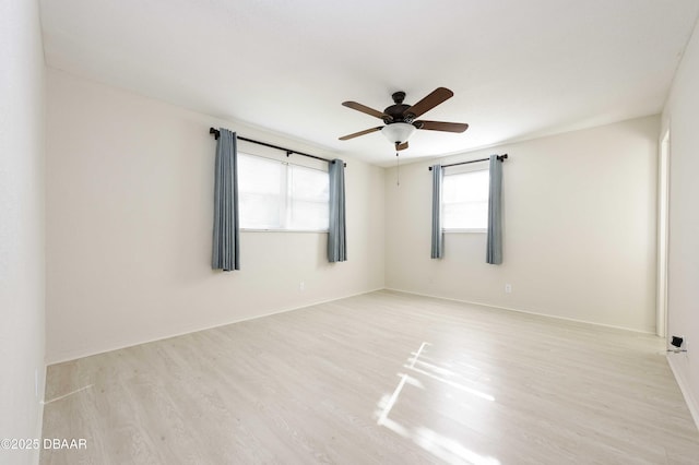 unfurnished room featuring ceiling fan and light hardwood / wood-style flooring