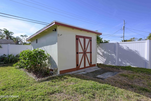 view of outbuilding featuring a yard