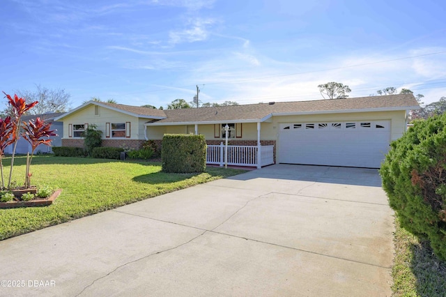 ranch-style house featuring a garage, covered porch, and a front lawn