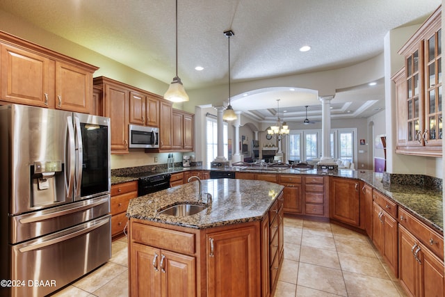 kitchen featuring kitchen peninsula, plenty of natural light, a textured ceiling, and appliances with stainless steel finishes