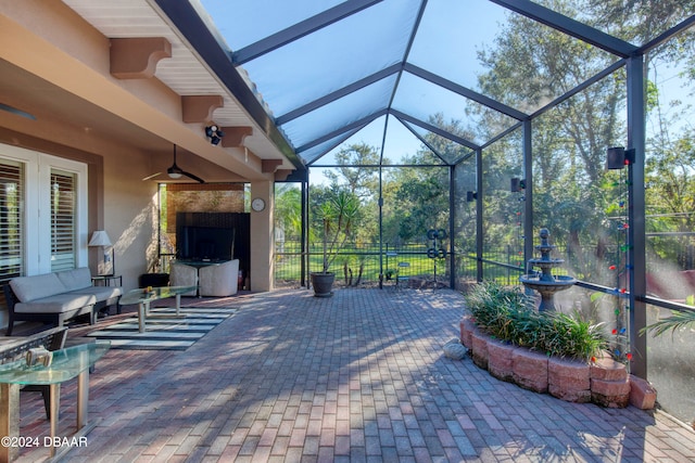 view of patio / terrace with ceiling fan and a lanai