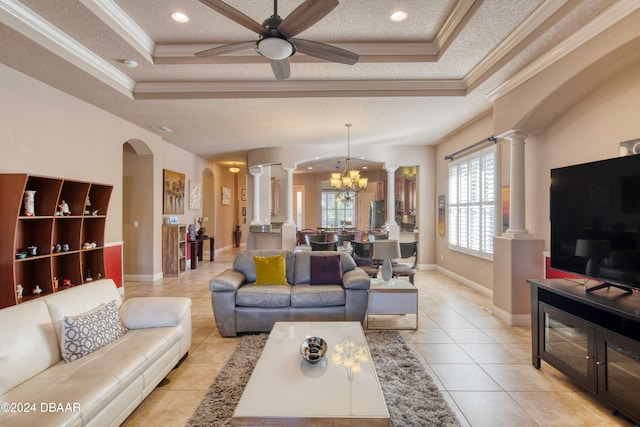 living room featuring a tray ceiling, crown molding, light tile patterned floors, and a textured ceiling