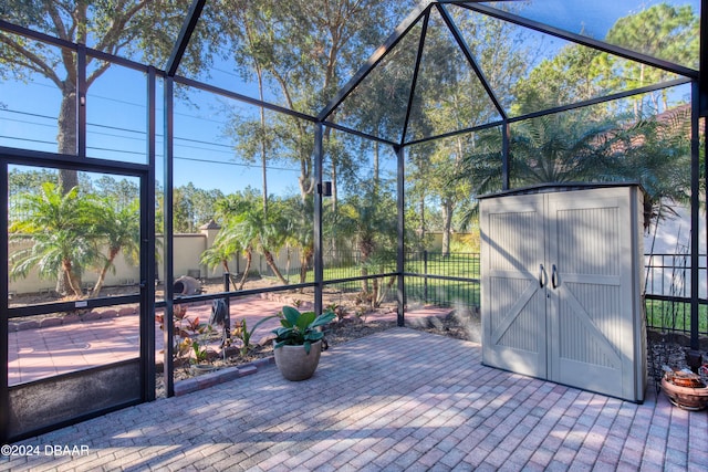 view of patio / terrace with a storage shed and a lanai