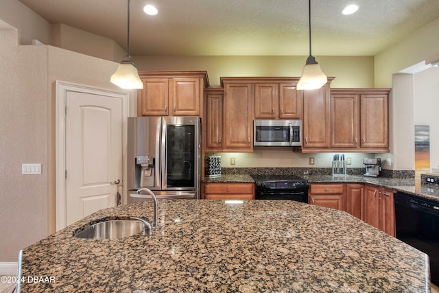 kitchen with sink, hanging light fixtures, dark stone countertops, and black appliances