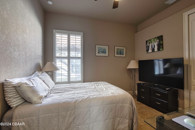 bedroom with light tile patterned floors and ceiling fan