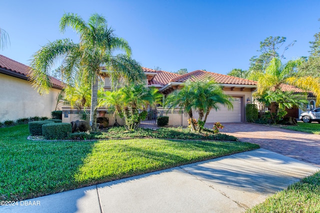 mediterranean / spanish-style house with a front lawn and a garage