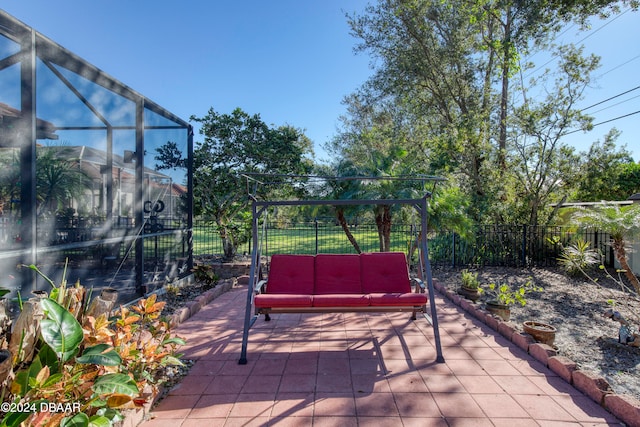 view of patio featuring glass enclosure