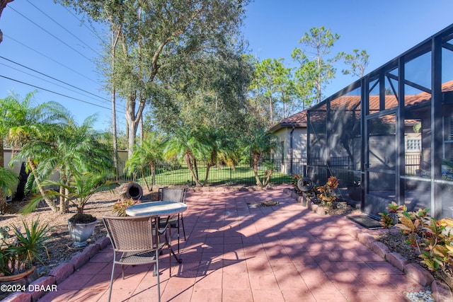 view of patio / terrace featuring glass enclosure